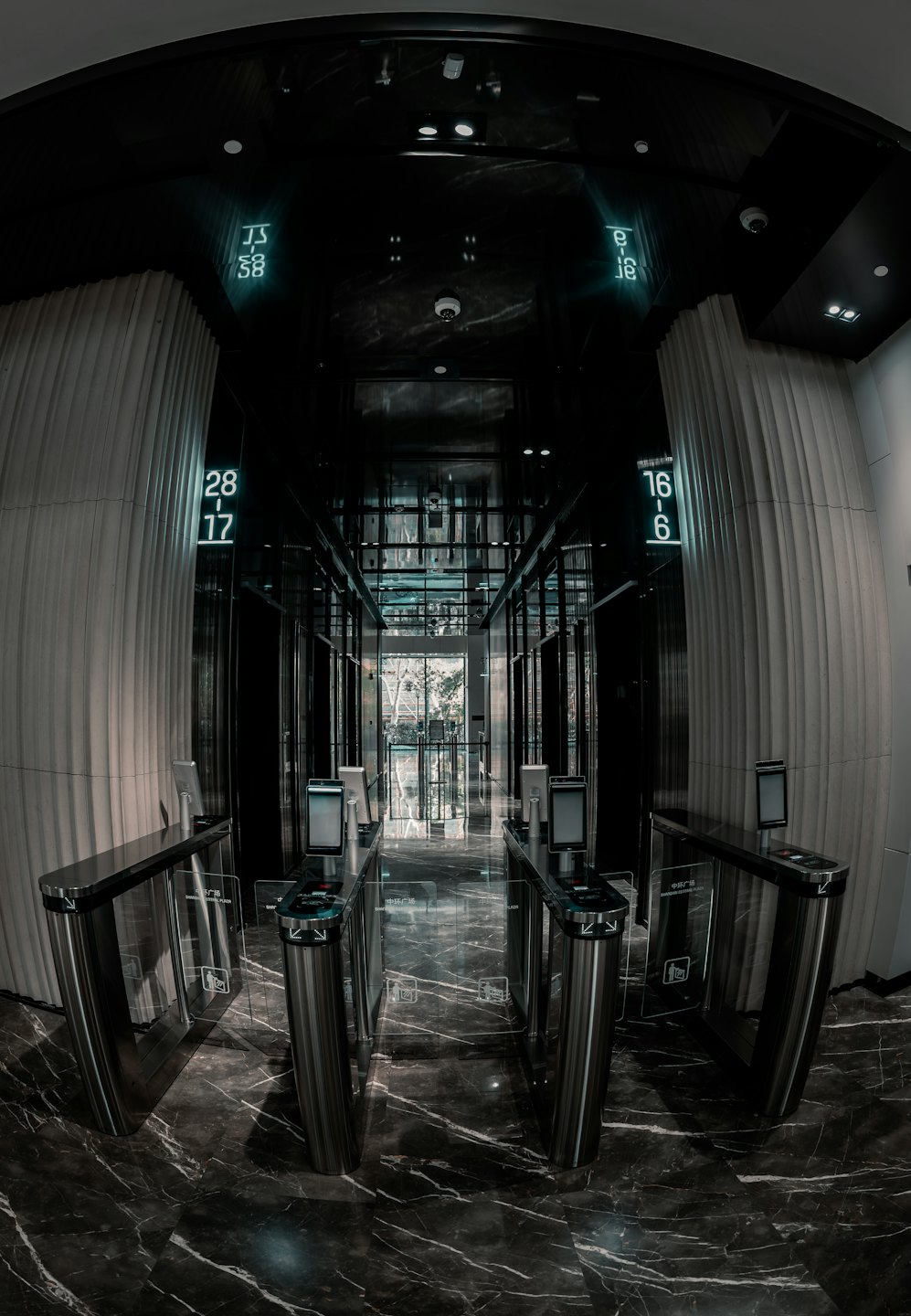 Tourniquets en acier inoxydable à l'entrée d'un immeuble d'entreprise épuré.
